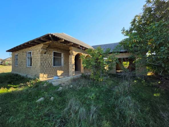 Недостроенный дом из лампача с шиферной крышей и двумя оконными проёмами на большом земельном участке в селе Конгаз.
